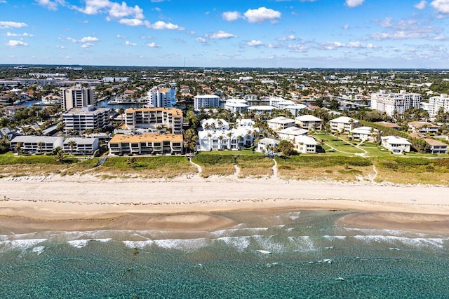 drone / aerial view featuring a view of the beach and a water view