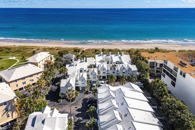 drone / aerial view featuring a water view and a beach view