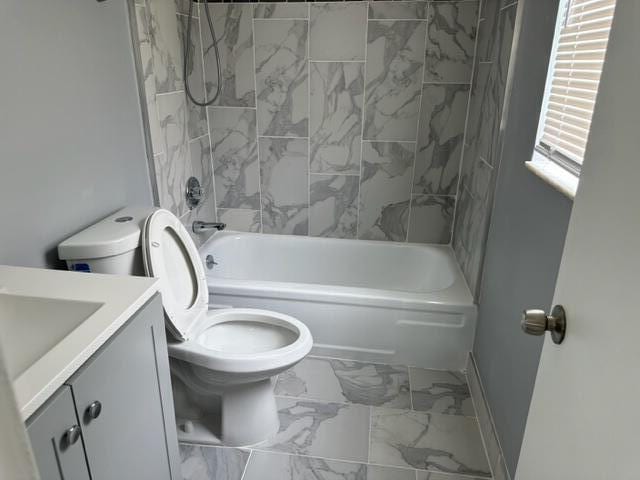 full bathroom featuring vanity, toilet, and tiled shower / bath