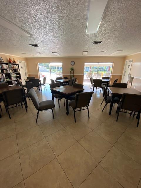 dining area with tile patterned flooring and a textured ceiling