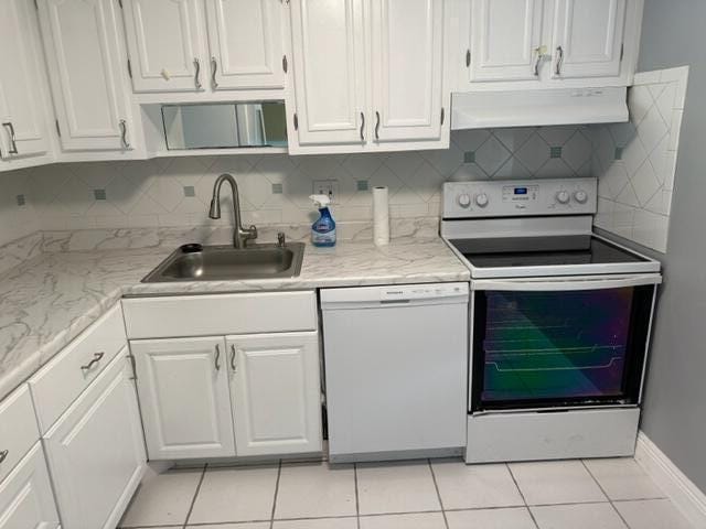 kitchen with white dishwasher, white cabinets, sink, range hood, and electric range oven