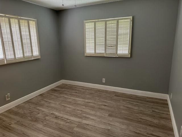 unfurnished room with hardwood / wood-style floors