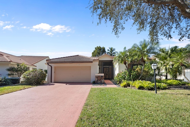 view of front of home with a garage, driveway, a tiled roof, stucco siding, and a front yard