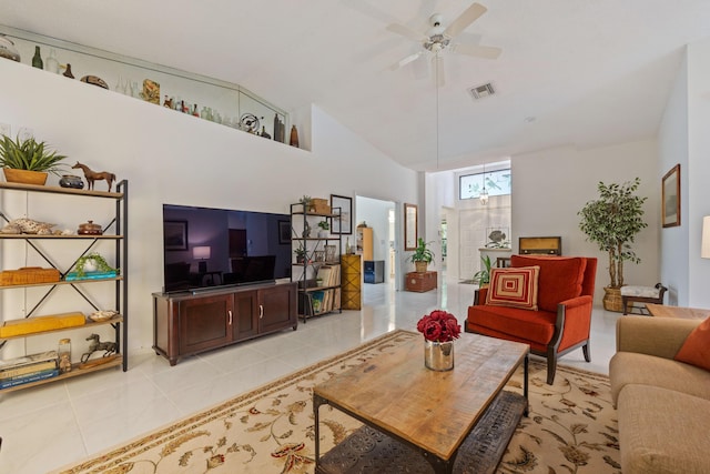 living room featuring ceiling fan with notable chandelier, high vaulted ceiling, and light tile patterned flooring