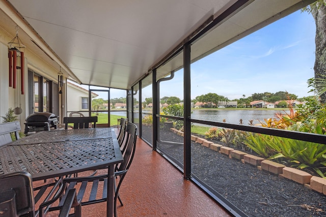 sunroom / solarium with a water view