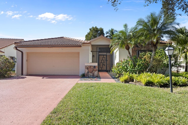 mediterranean / spanish-style home with a front lawn and a garage