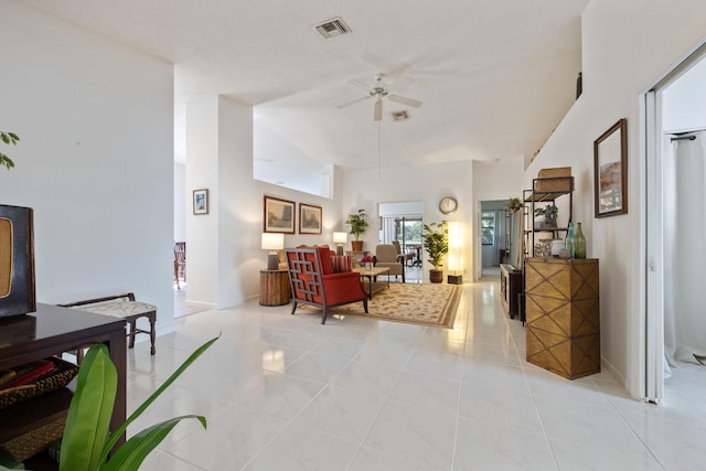 living room with ceiling fan, light tile patterned floors, and high vaulted ceiling