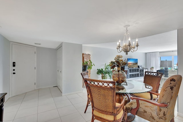 tiled dining room featuring a notable chandelier