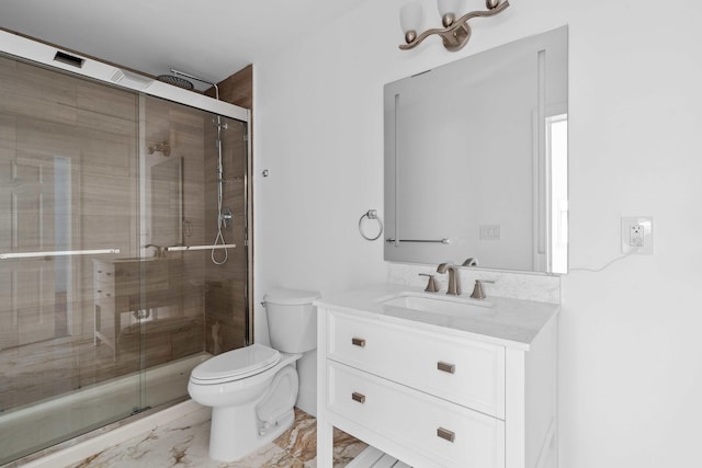 bathroom with vanity, toilet, and an enclosed shower