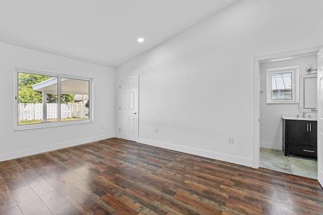 interior space with dark hardwood / wood-style flooring, lofted ceiling, and sink