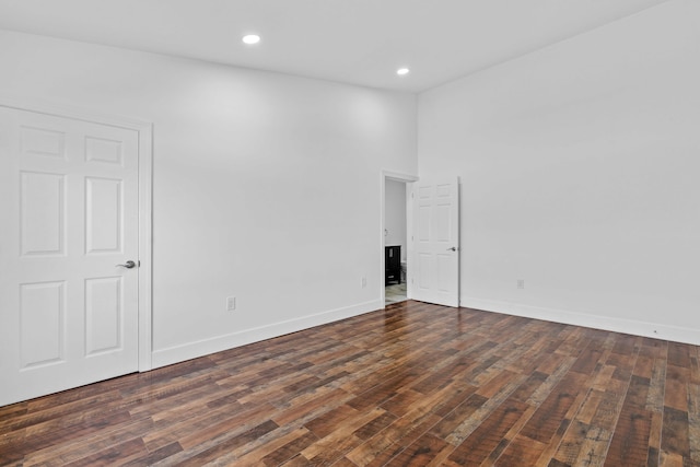 empty room featuring dark hardwood / wood-style flooring