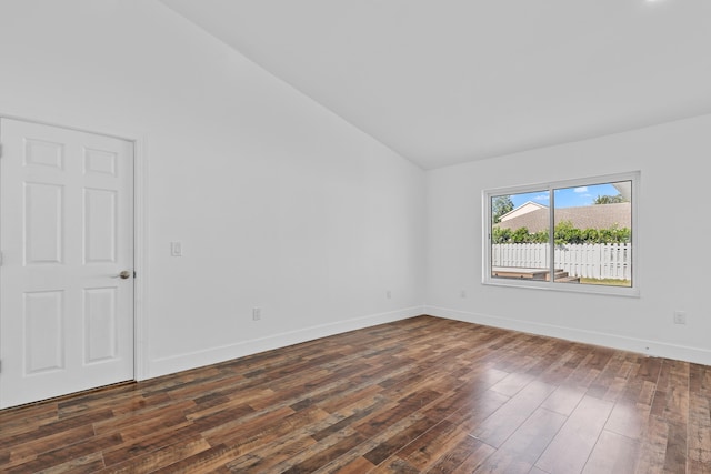 unfurnished room featuring lofted ceiling and dark wood-type flooring