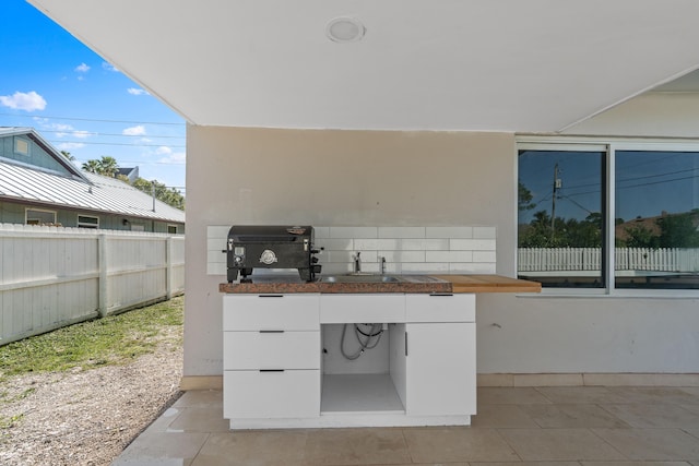 view of patio with a grill and sink