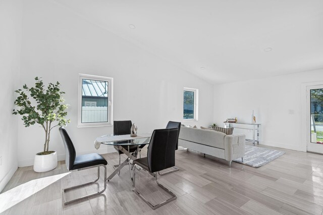 kitchen featuring white range with electric cooktop, white cabinetry, sink, and a large island with sink