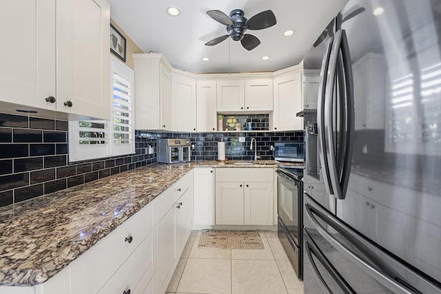 kitchen featuring tasteful backsplash, white cabinets, fridge with ice dispenser, a sink, and black range with electric cooktop