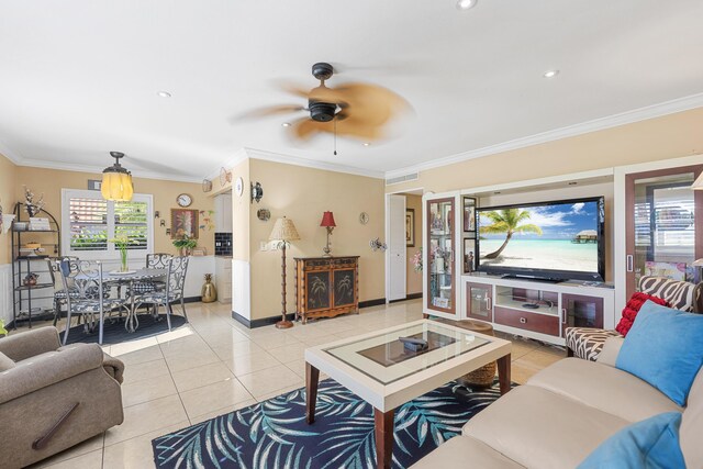 tiled dining area with ceiling fan and ornamental molding