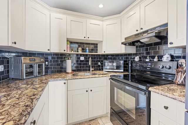 kitchen featuring decorative backsplash, white cabinetry, sink, and black electric range