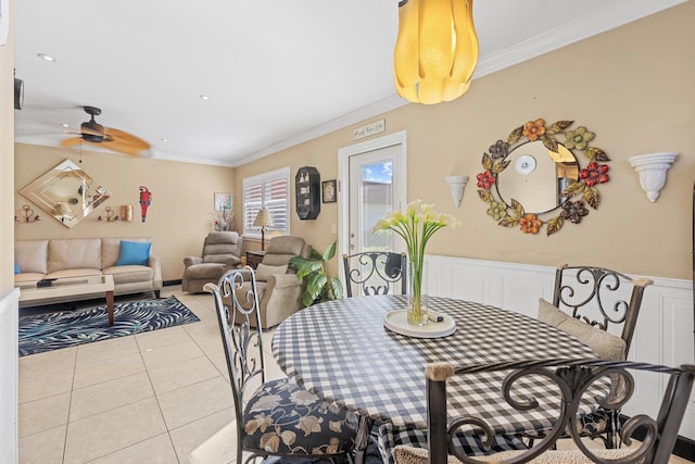 dining area featuring light tile patterned floors, ceiling fan, recessed lighting, a wainscoted wall, and ornamental molding