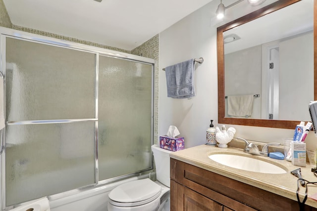 full bathroom featuring bath / shower combo with glass door, toilet, and vanity