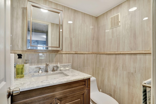 bathroom featuring toilet and vanity