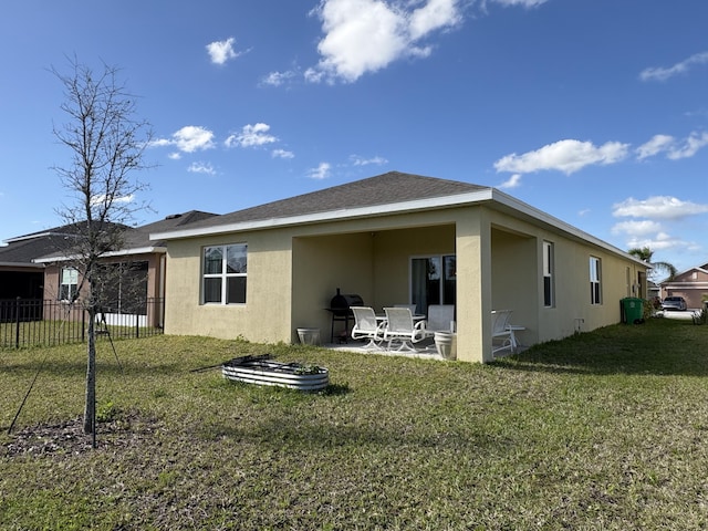 back of property with a patio and a lawn