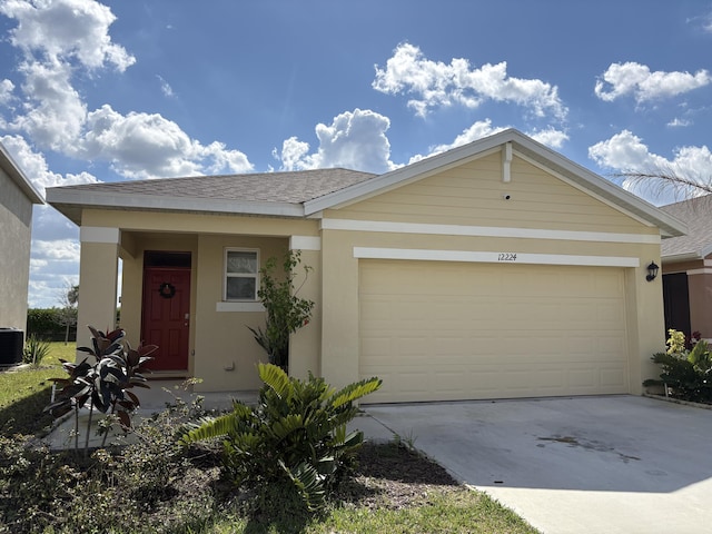 ranch-style home with cooling unit and a garage