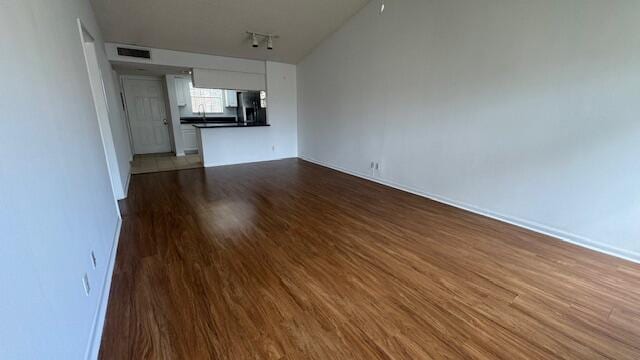 unfurnished living room with hardwood / wood-style flooring