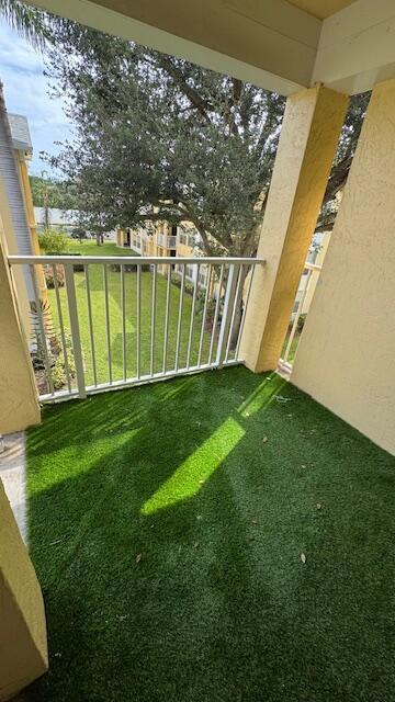 view of yard with a balcony