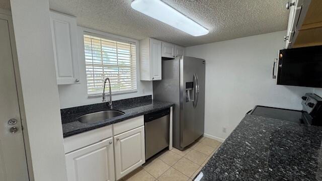 kitchen with sink, white cabinets, a textured ceiling, and appliances with stainless steel finishes