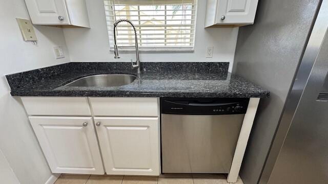 kitchen with sink, white cabinetry, stainless steel appliances, and dark stone counters