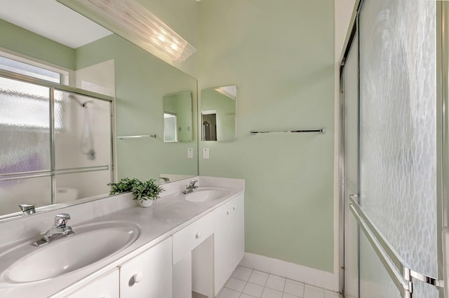 bathroom with an enclosed shower, vanity, and tile patterned flooring