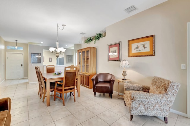 tiled dining room with a chandelier