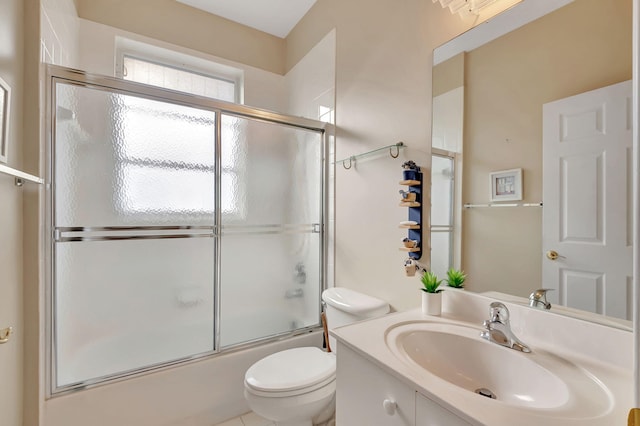 full bathroom featuring toilet, vanity, and shower / bath combination with glass door