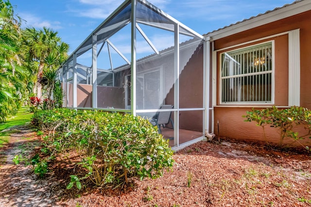 view of property exterior with a lanai