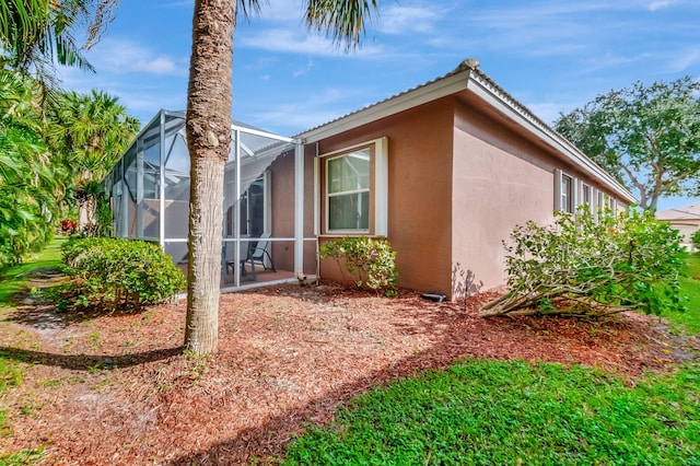 view of property exterior with a lanai