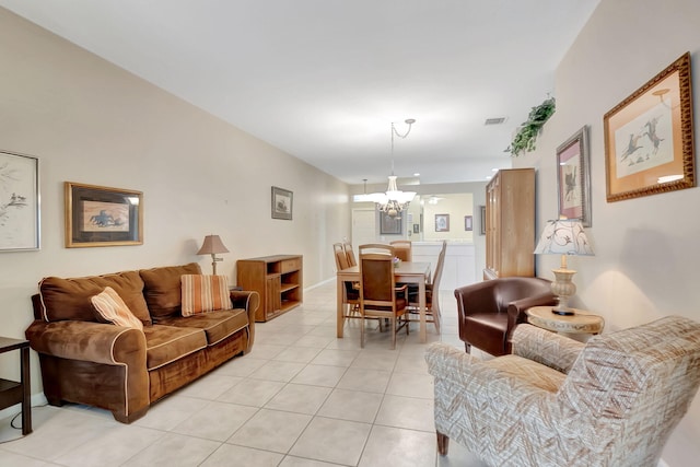 living room featuring a notable chandelier and light tile patterned flooring