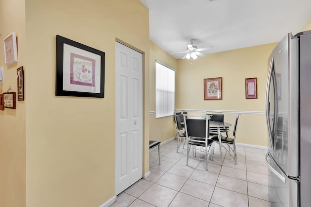 tiled dining room featuring ceiling fan