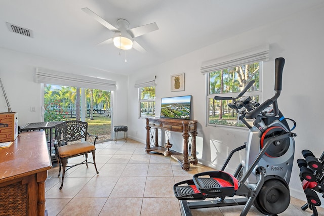 exercise area featuring ceiling fan and light tile patterned floors