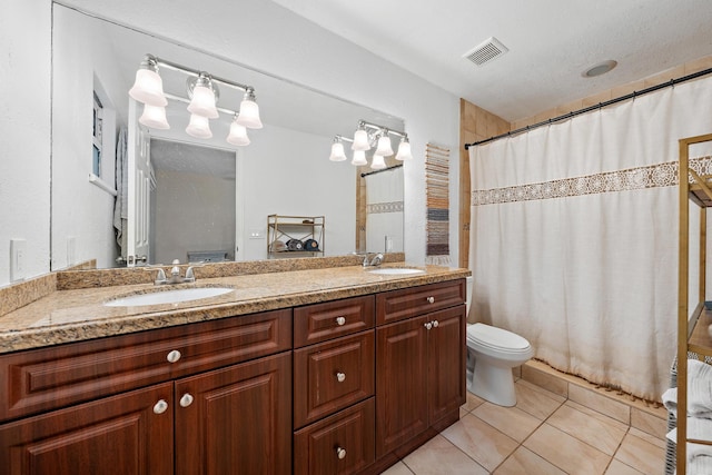 bathroom with curtained shower, tile patterned flooring, vanity, and toilet