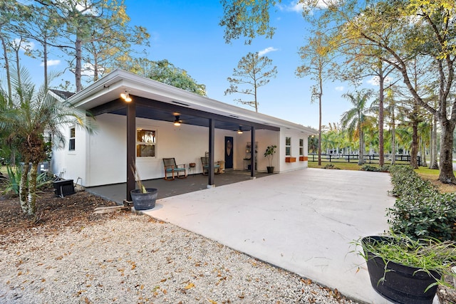 back of house with ceiling fan and a patio