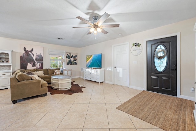 living room with ceiling fan and light tile patterned floors