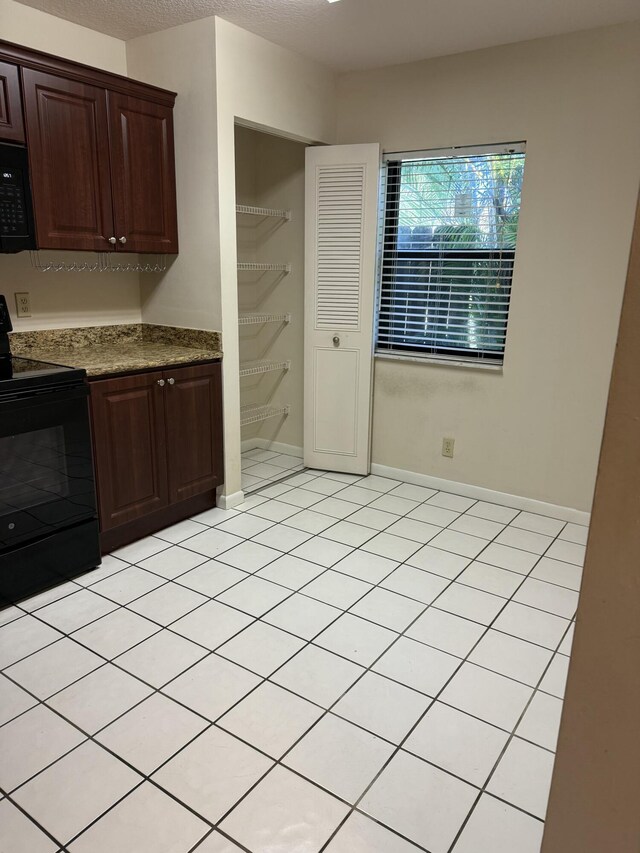 bathroom featuring shower / bath combo and tile patterned floors