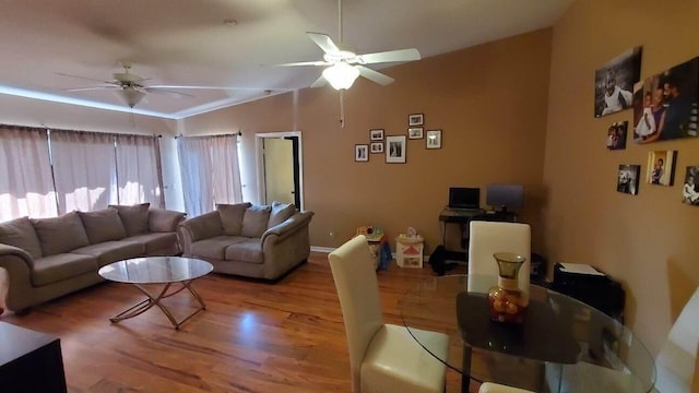 living room with light hardwood / wood-style floors, vaulted ceiling, and ceiling fan