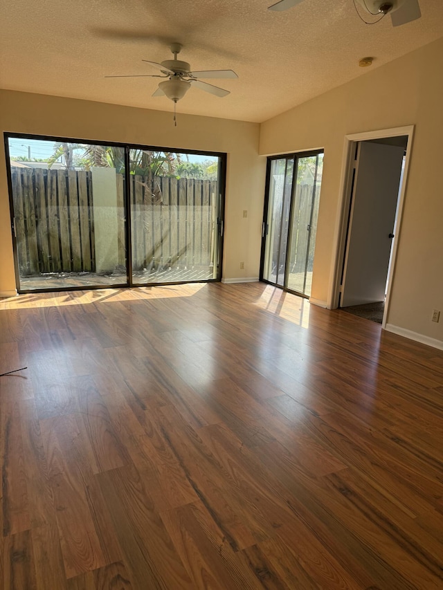 unfurnished room with ceiling fan, dark hardwood / wood-style floors, and a textured ceiling