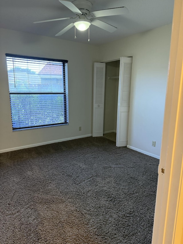 unfurnished bedroom featuring carpet floors, ceiling fan, and a closet