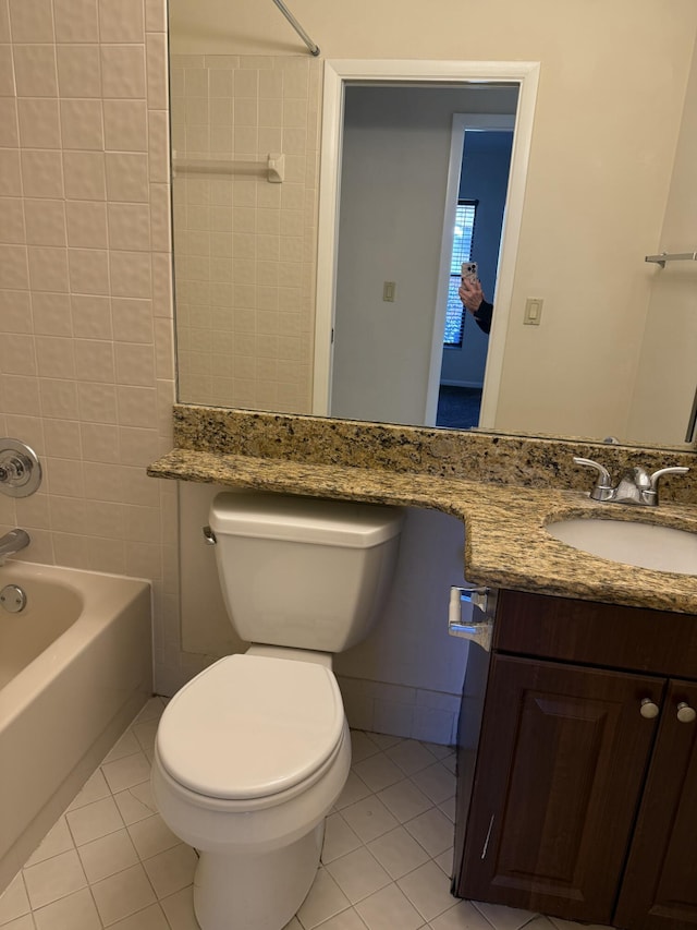 full bathroom with vanity, toilet, tiled shower / bath combo, and tile patterned flooring