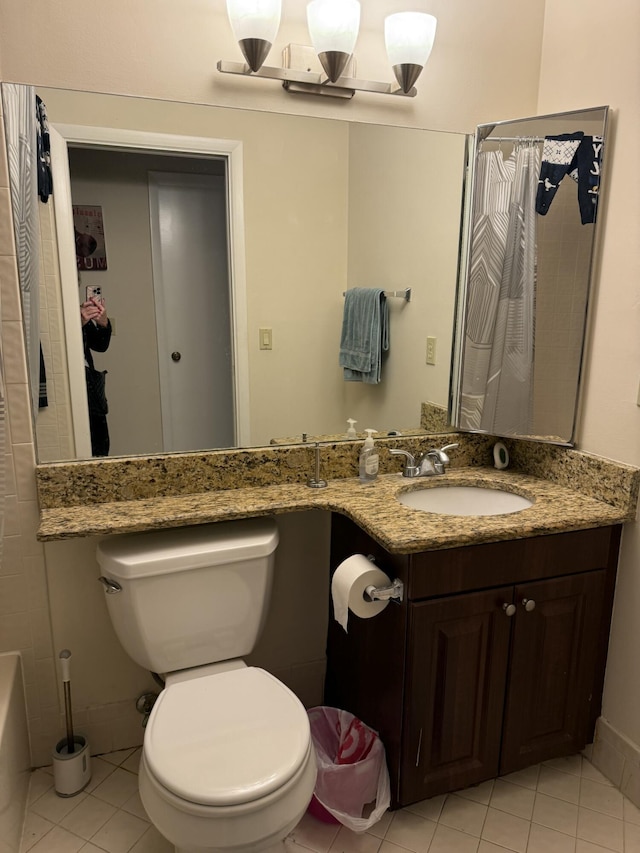 bathroom with tile patterned flooring, vanity, and toilet