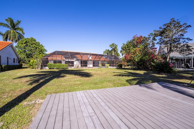 wooden deck with glass enclosure and a yard