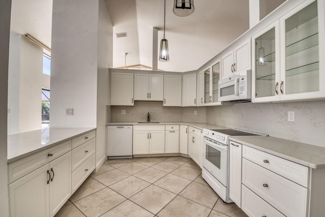 kitchen with backsplash, white appliances, sink, and light tile patterned floors