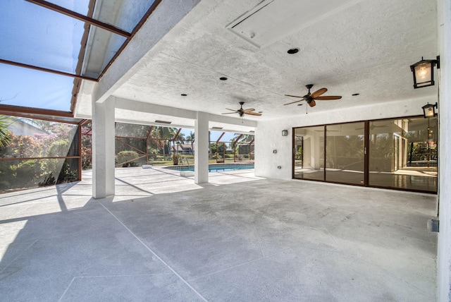 view of patio featuring ceiling fan and a lanai